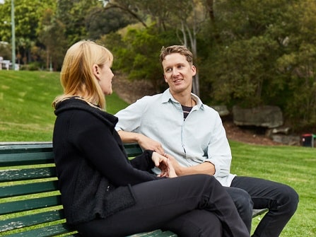 student talking with counsellor on bench